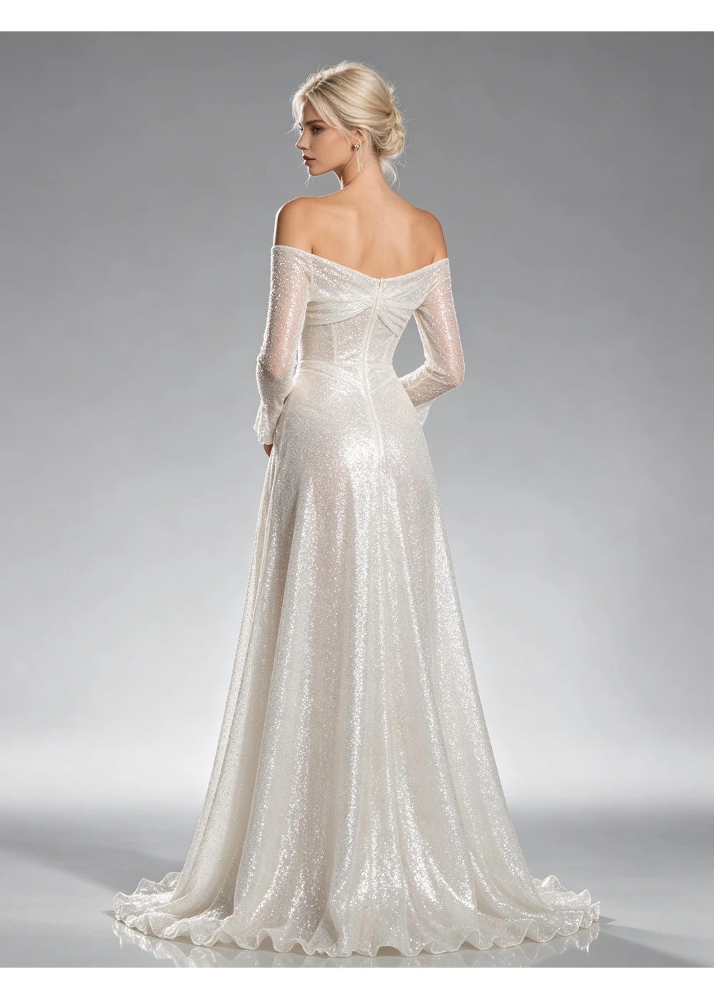Back view of the white sequin gown showing the folded shoulder line and widening lower skirt