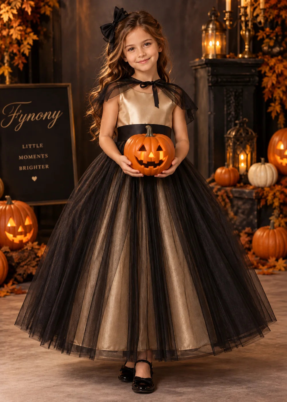 Front view of the champagne and black flower girl dress.
