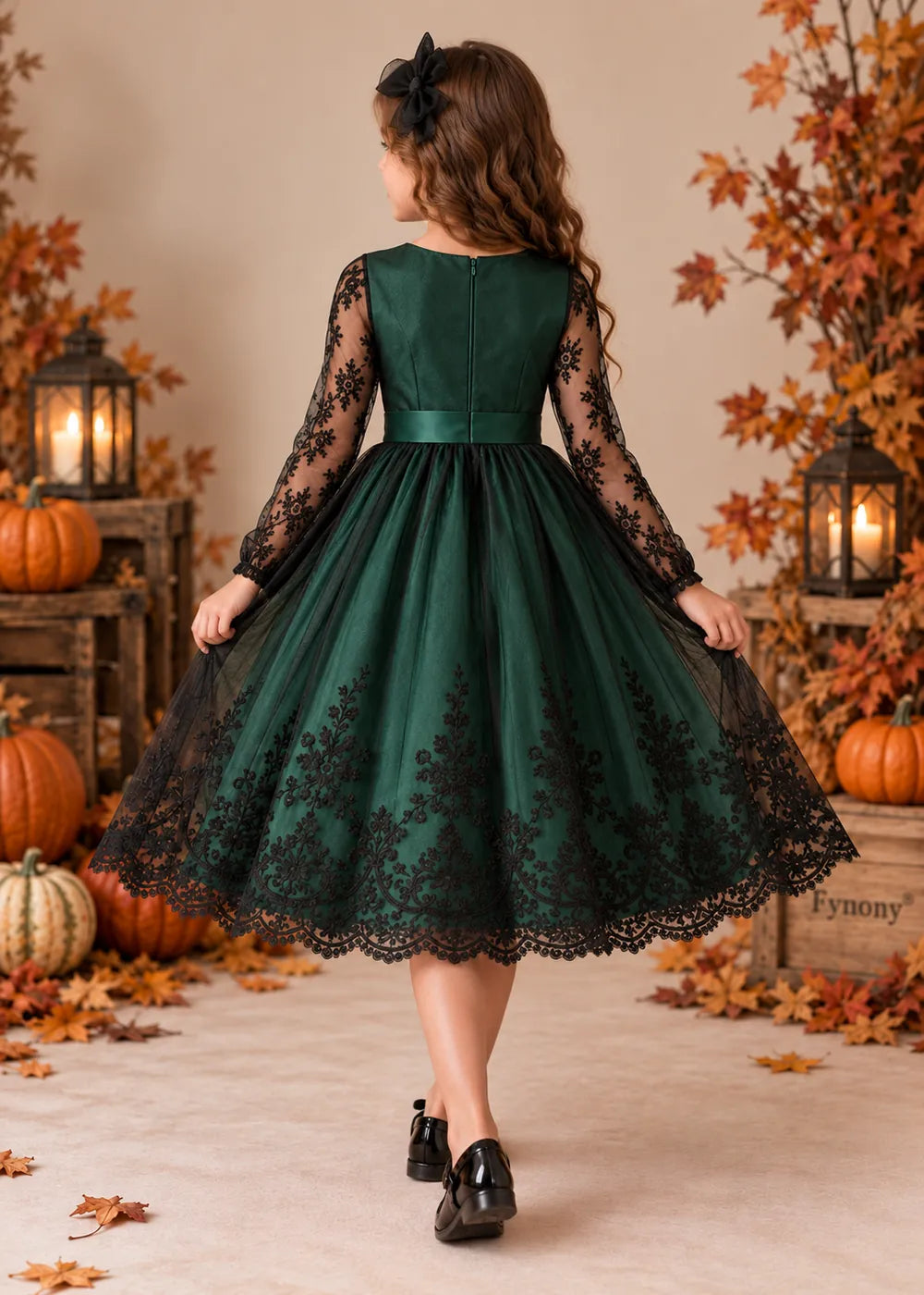 Back view of the dark green and black flower girl dress.