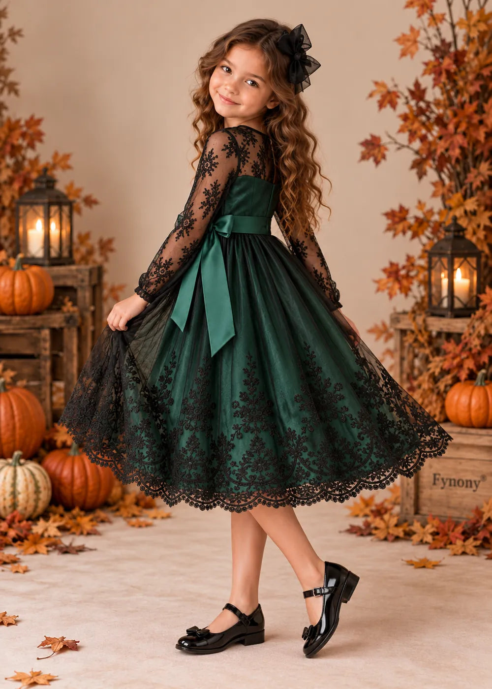 Detail view of the dark green and black flower girl dress.