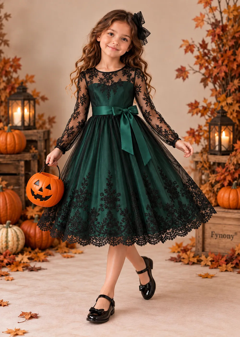 Detail view of the dark green and black flower girl dress.