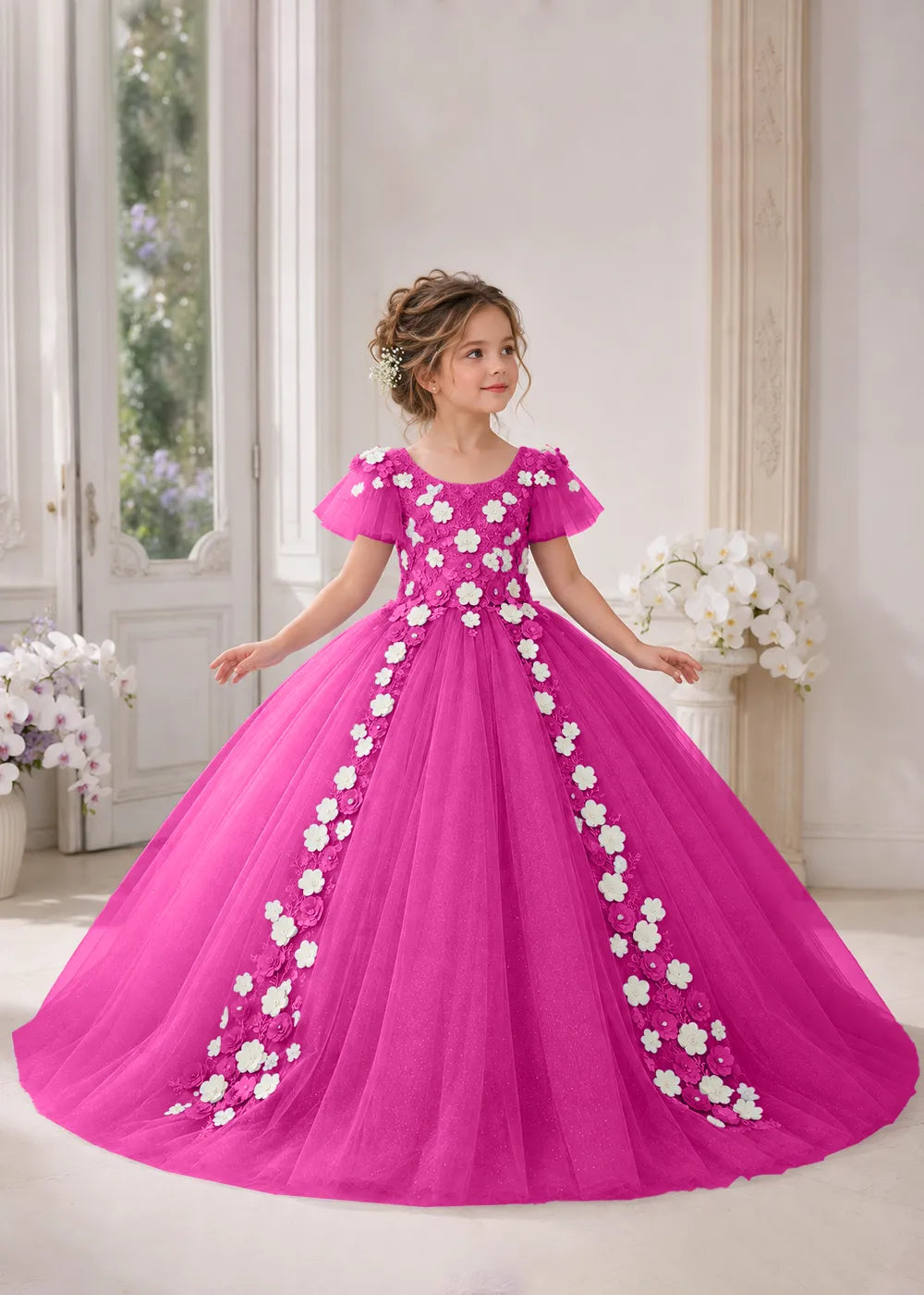 Front view of a child wearing a hot pink flower girl dress with a round neckline, sheer flutter cap sleeves and a floral vine cascading down both sides of a full tulle skirt.