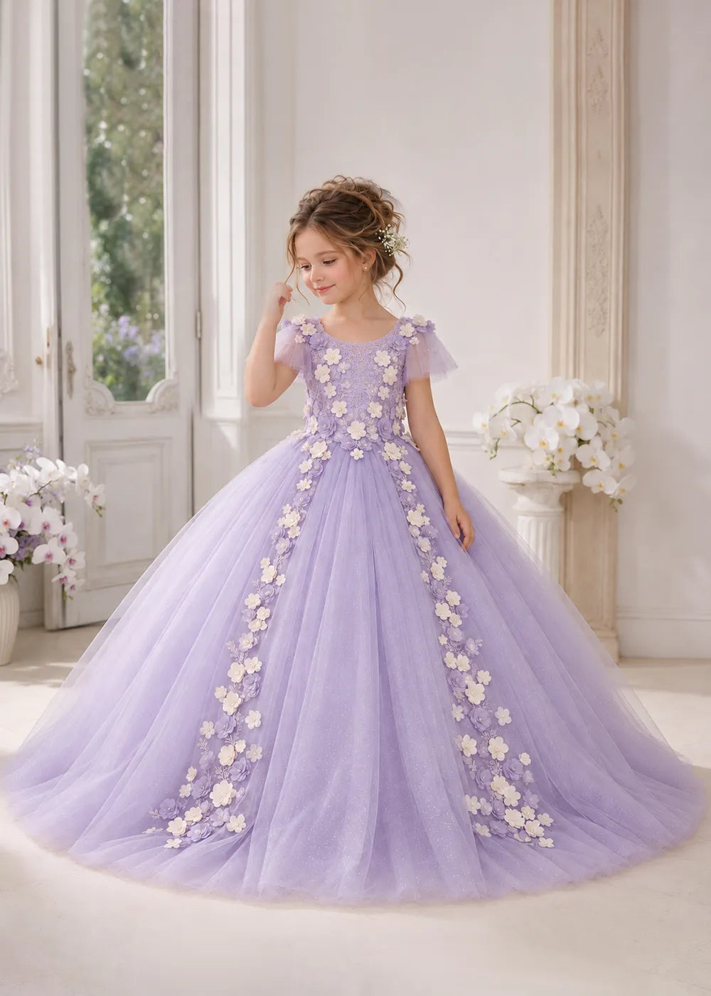 The front view of a child wearing a Lilac flower girl dress with a round neckline, sheer flutter cap sleeves and a floral vine cascading down both sides of a full tulle skirt.