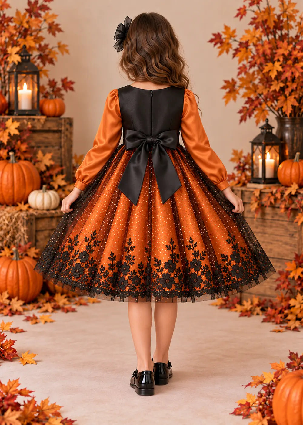 Back view of the orange and black flower girl dress.
