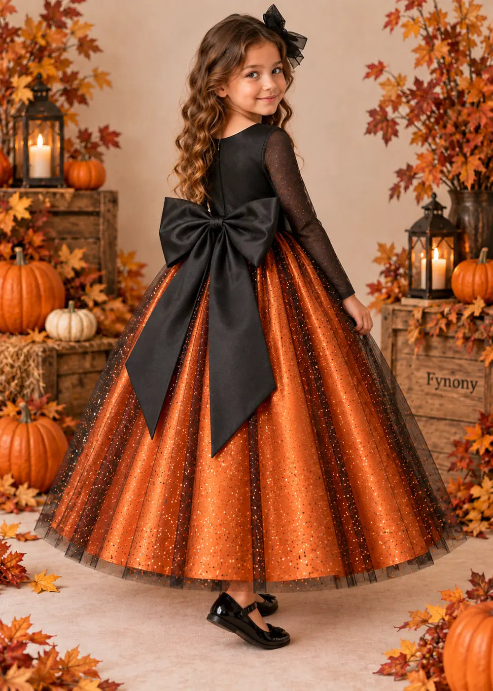 Side back view of the orange and black flower girl dress.