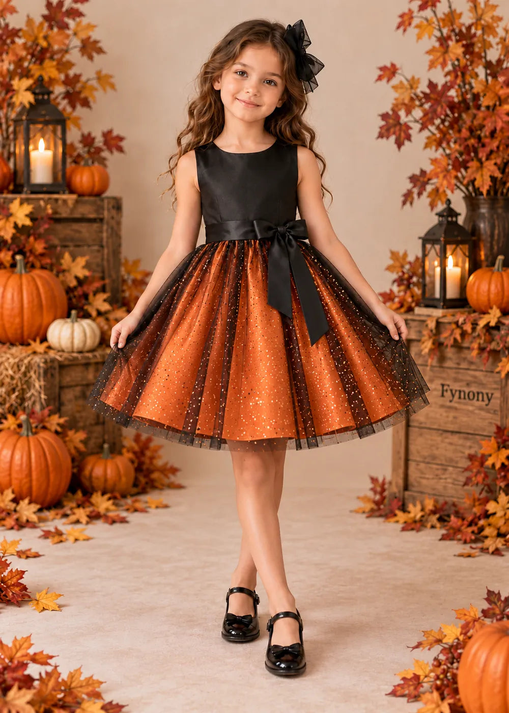 Front view of the orange and black flower girl dress.
