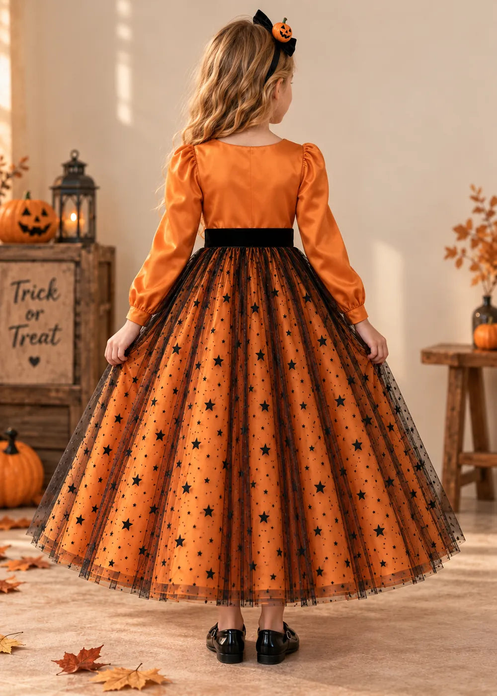 Back view of the orange and black flower girl dress.