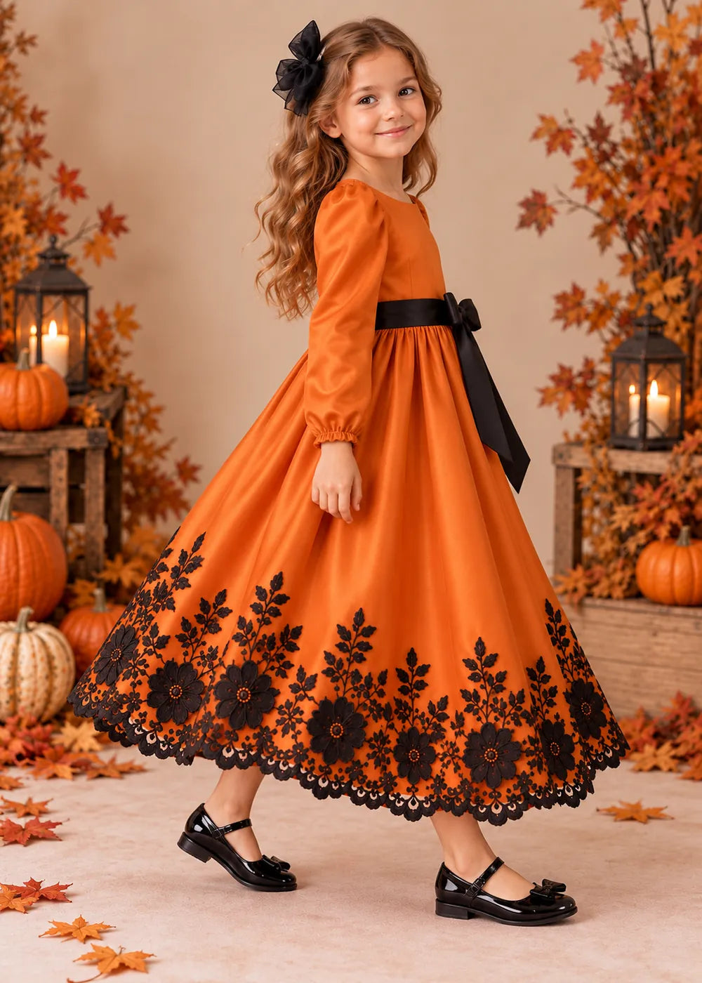Detail view of the orange and black flower girl dress.