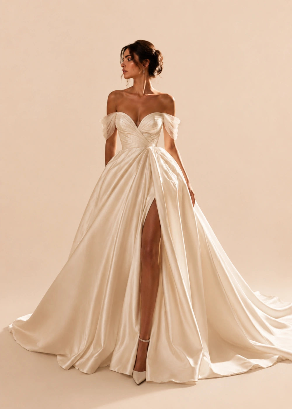 Front view of the champagne off-the-shoulder A-line gown with a corset bodice, high slit, and train
