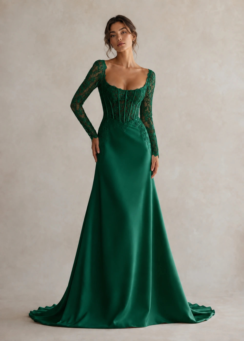 Front view of the emerald green square-neck fitted gown with long floral-lace sleeves and a softly flared train