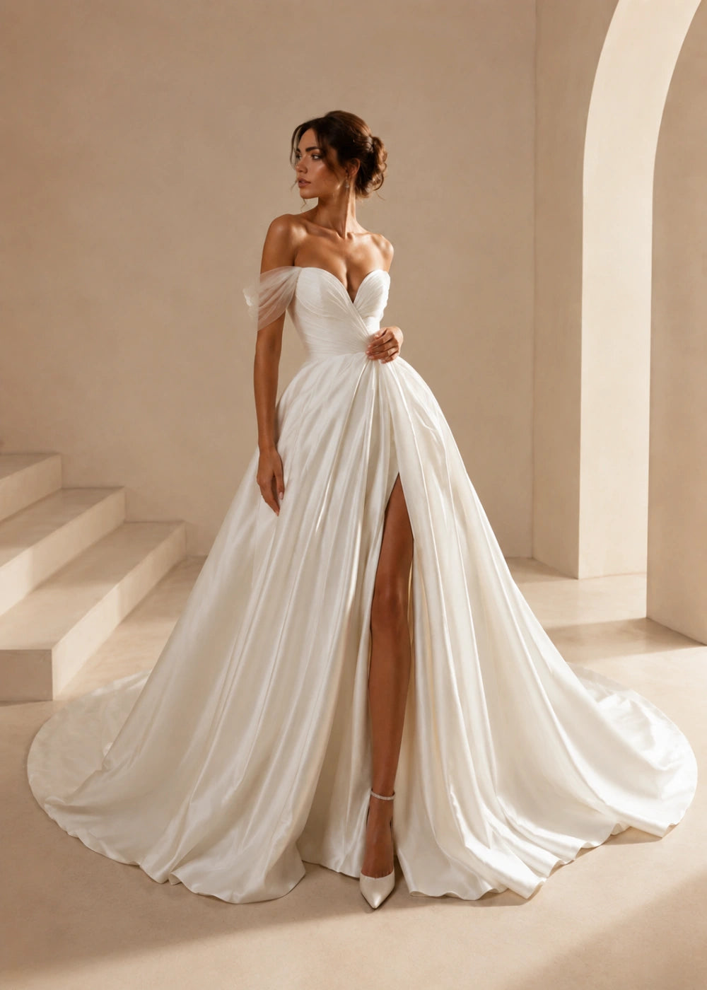 Front view of the ivory off-the-shoulder A-line gown with a corset bodice, high slit, and train