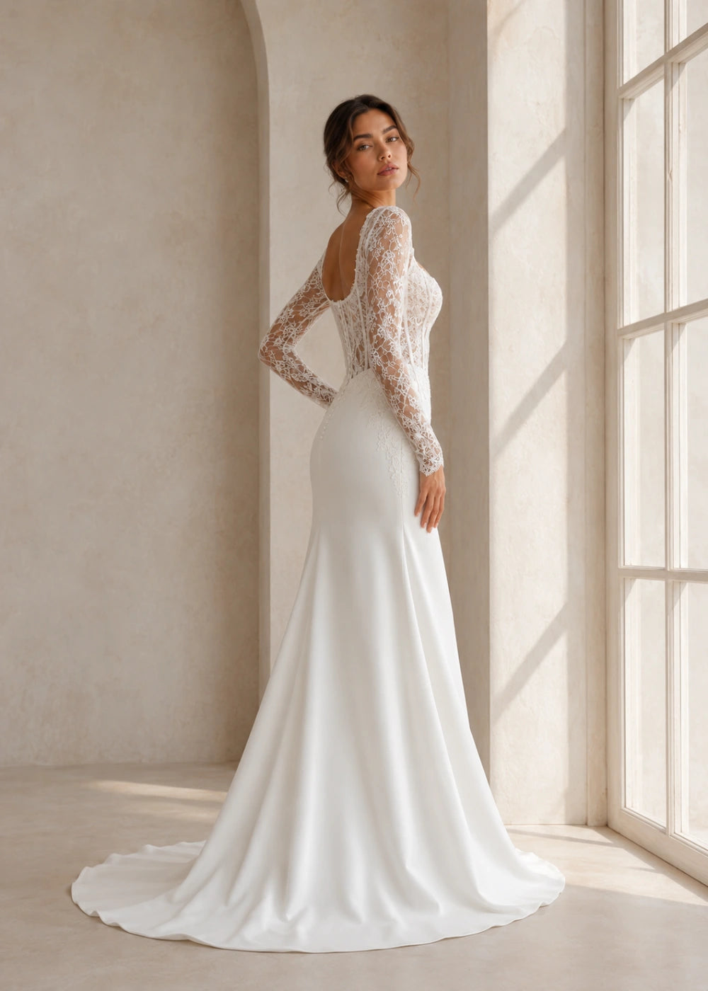 Left side and front three-quarter view of an ivory fitted gown showing the sleeve, bodice, and train