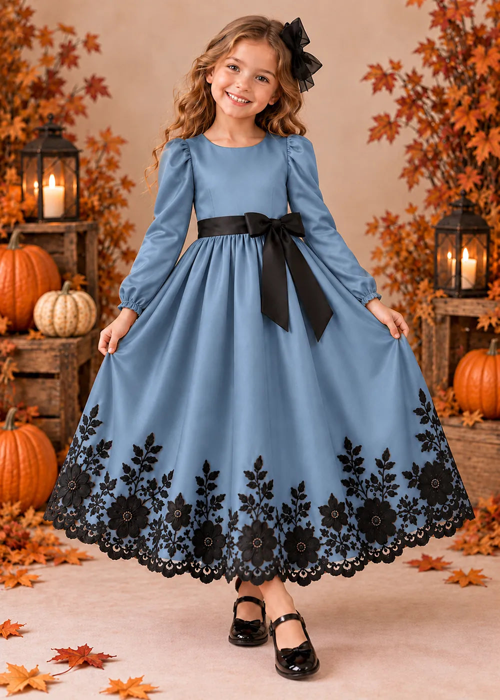 Front view of a dusty blue long-Sleeve Flower Girl Dress with Black Floral Hem.