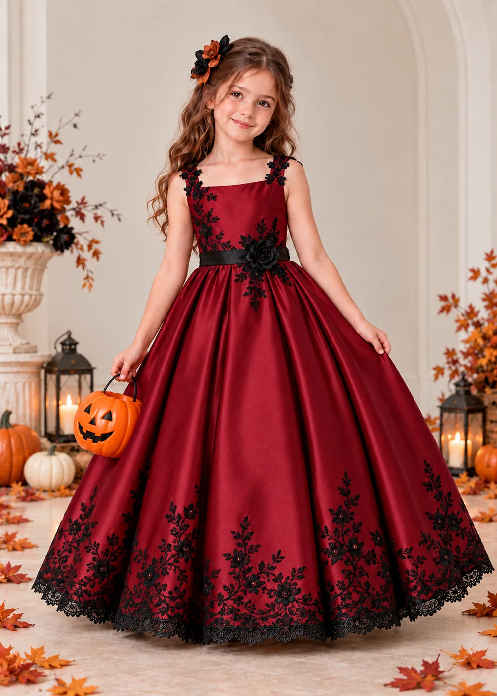 Front view of a burgundy flower Girl Dress with Black Floral Straps and Hem.