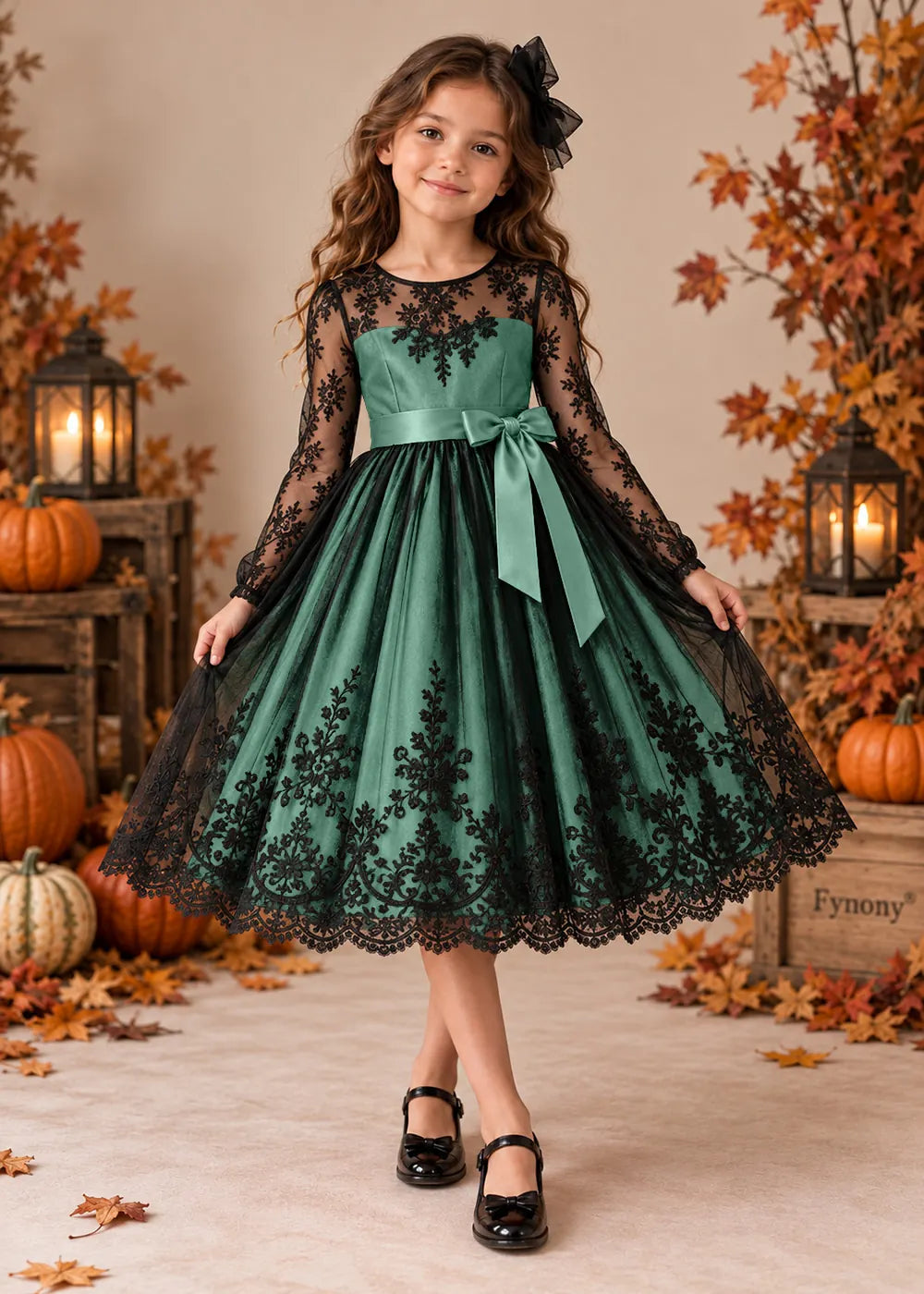 Front view of a light green flower Girl Dress with Black Lace and Long Sleeves.