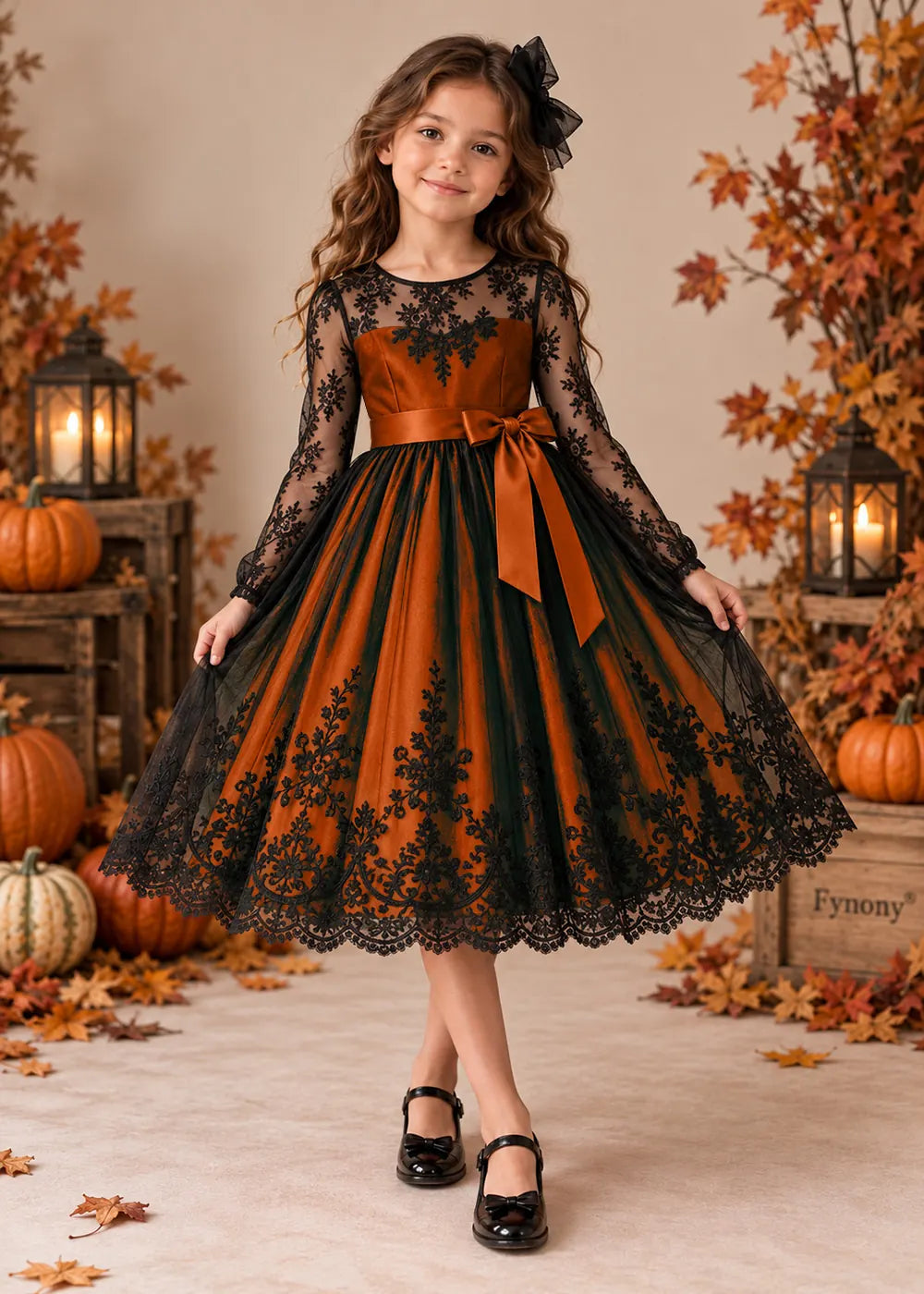Front view of a orange flower Girl Dress with Black Lace and Long Sleeves.
