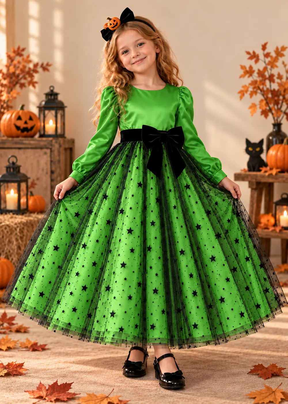 Front view of a light green long-sleeve star tulle flower girl dress with bow.