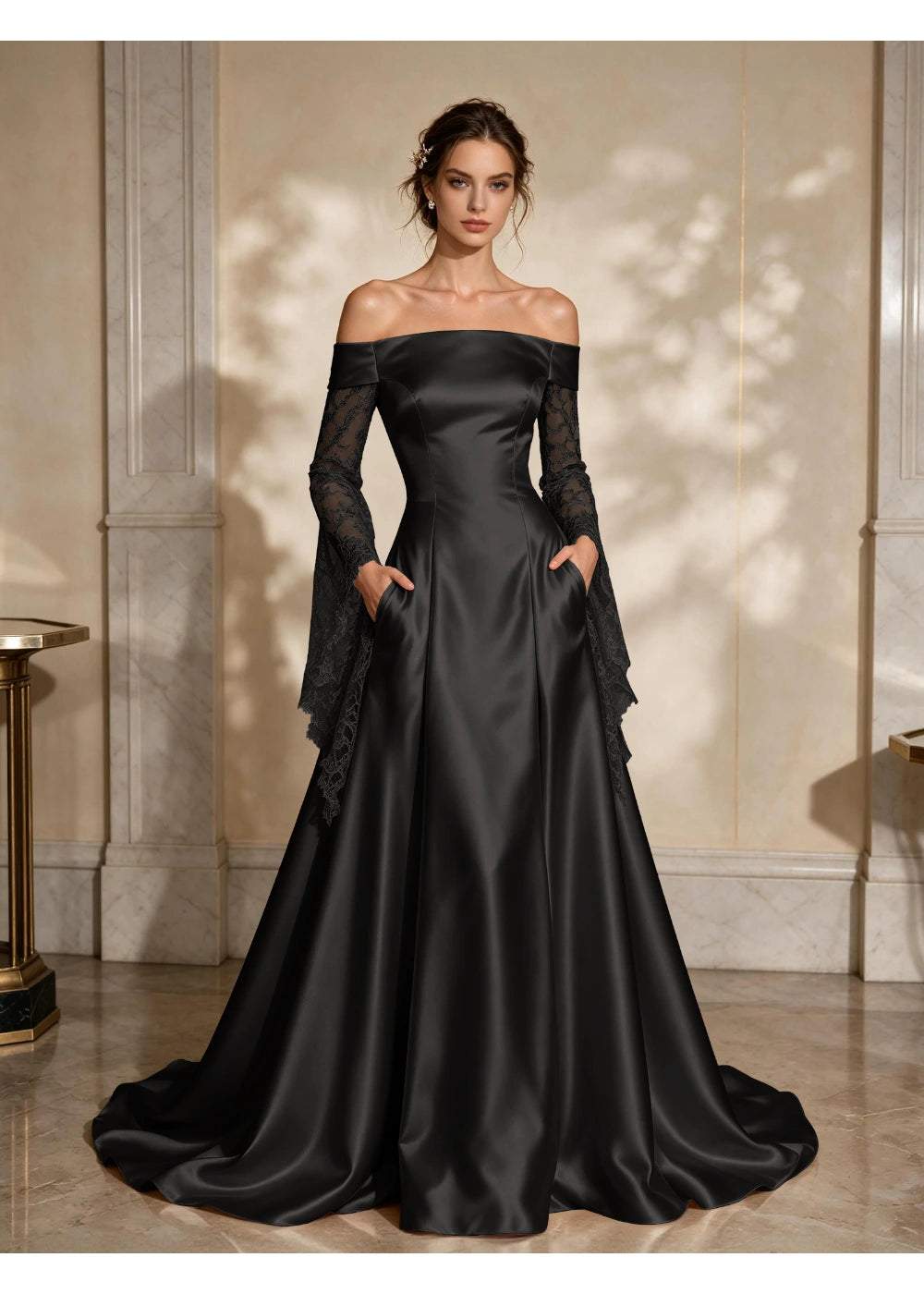 Front view of a black satin A-line gown with a folded off-shoulder neckline and draped lace sleeve extensions
