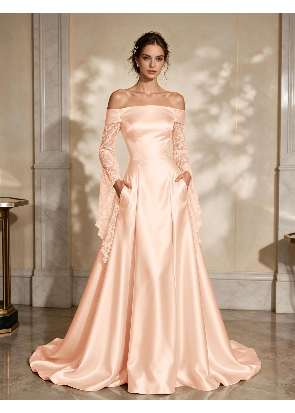 Front view of a blush pink satin A-line gown with a folded off-shoulder neckline and draped lace sleeve extensions