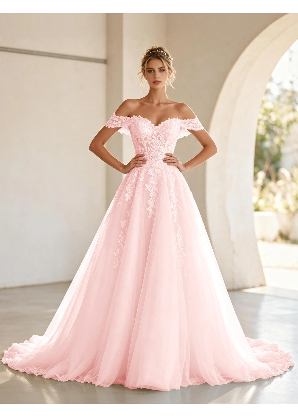 Front view of the blush pink off shoulder lace tulle gown with the same bridal silhouette