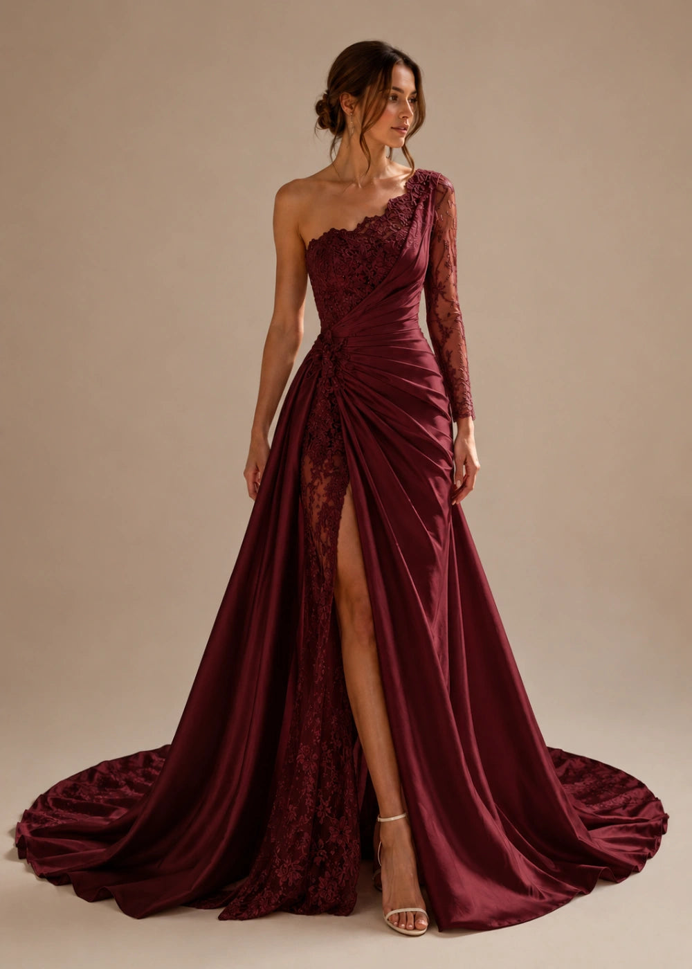 Front view of the burgundy one-shoulder fitted gown with one long lace sleeve, a thigh-high slit, and a train