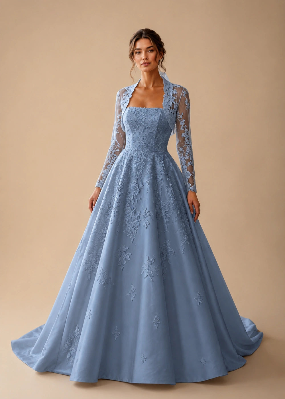Front view of the dusty blue square-neck A-line gown with a long-sleeve lace bolero-style overlay