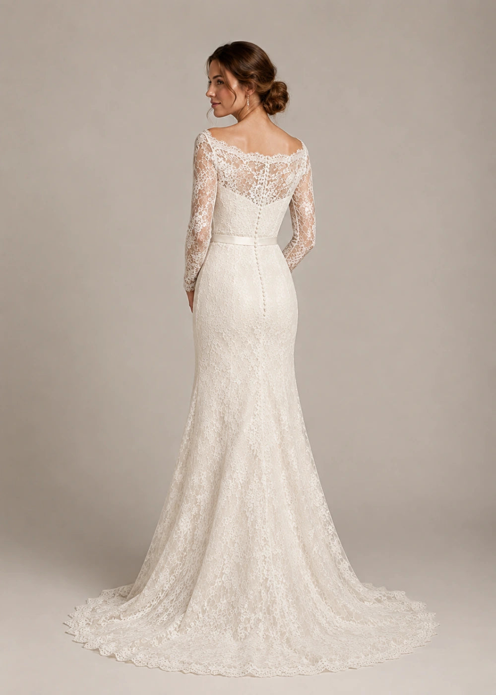 Back view of an ivory lace mermaid gown showing the fitted silhouette and flared train