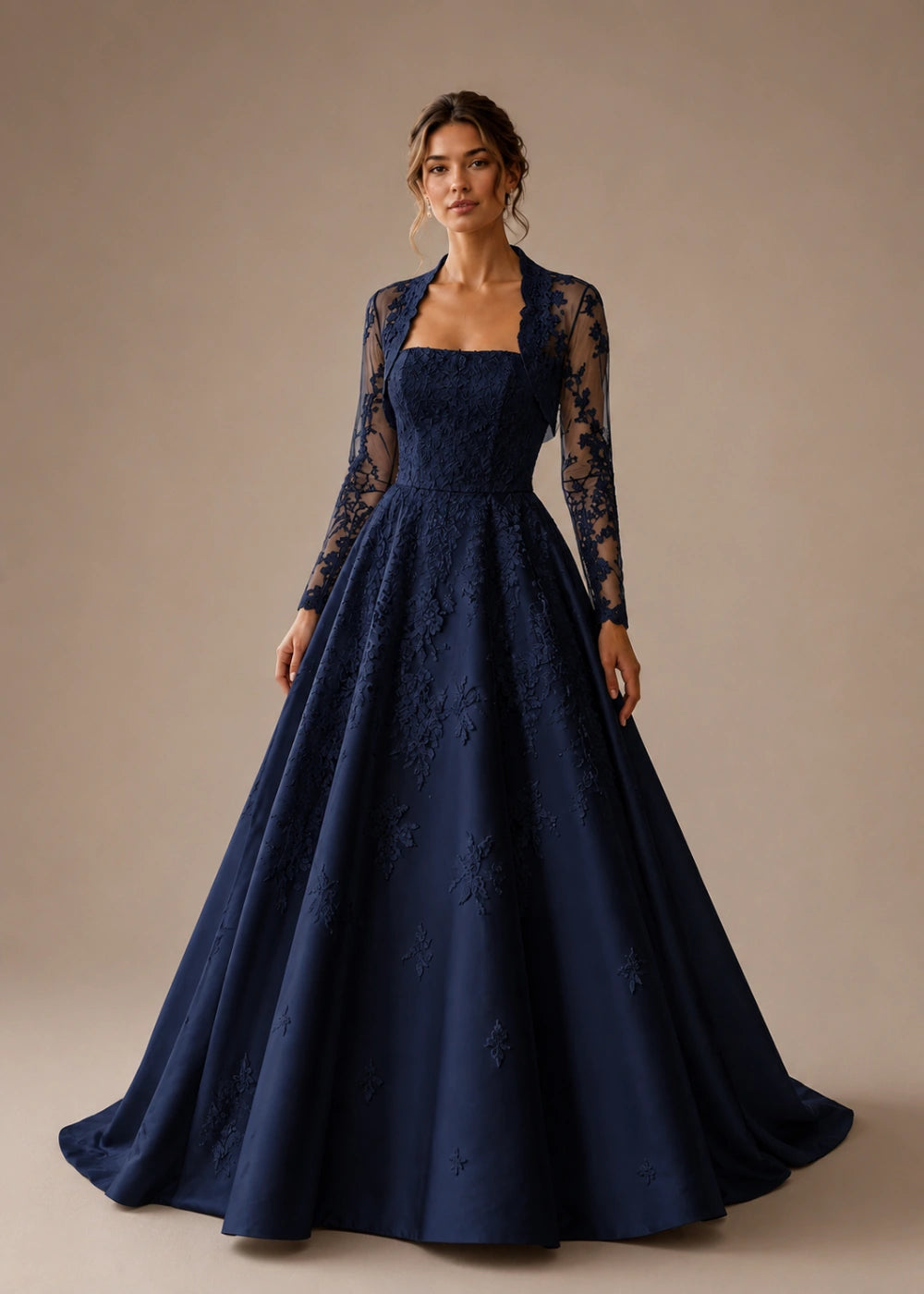 Front view of the navy blue square-neck A-line gown with a long-sleeve lace bolero-style overlay