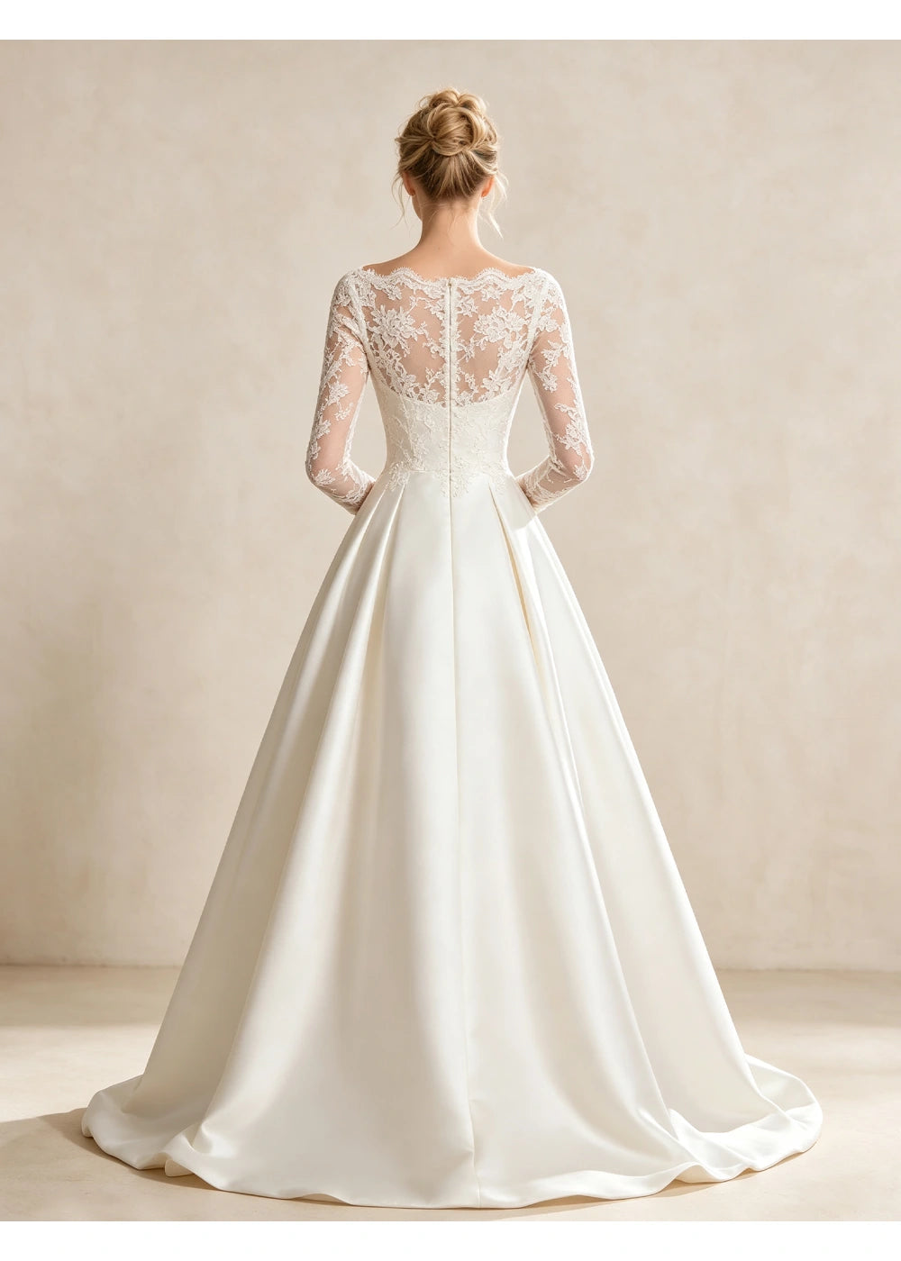 Back view of the white gown showing a sheer floral lace upper back above the satin skirt