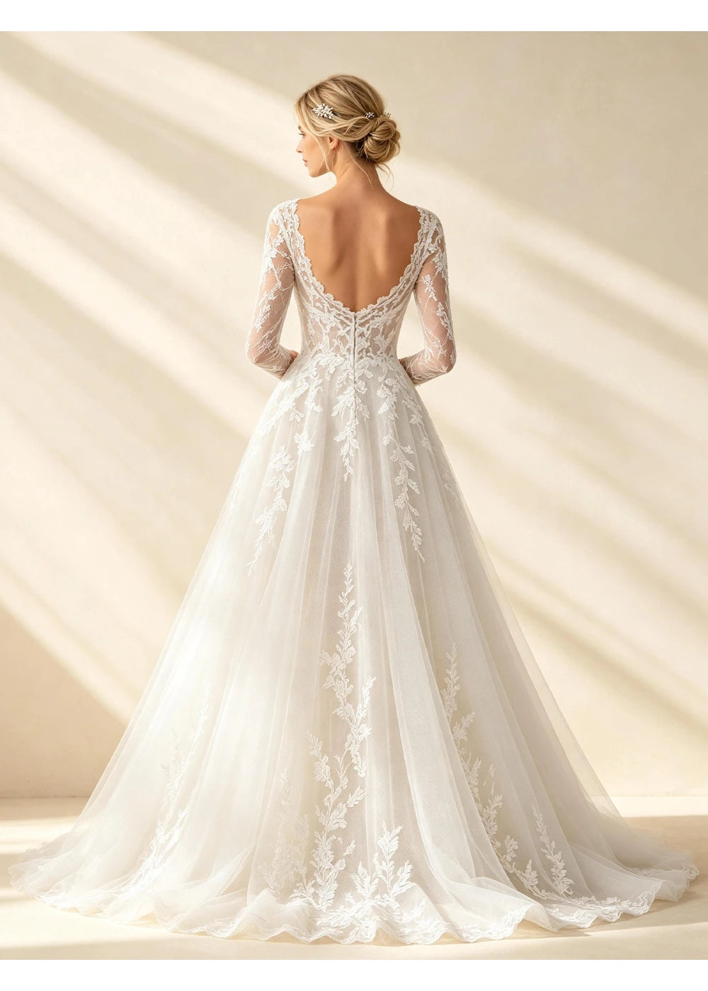 Back view of the white lace gown showing a low curved neckline and full train
