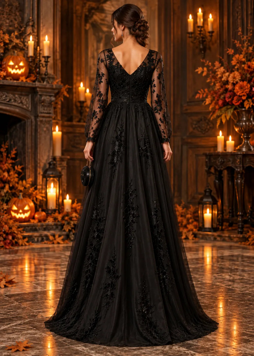 Back view of the black gown showing its V-shaped back, floral sleeves and vine appliqués on the skirt.