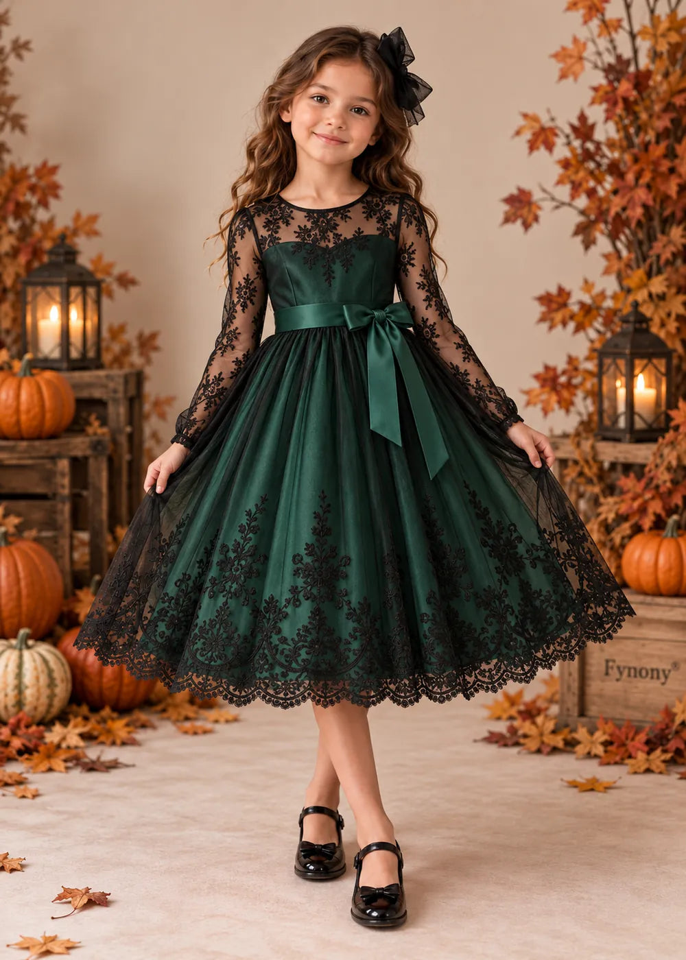 Front view of the dark green and black flower girl dress.