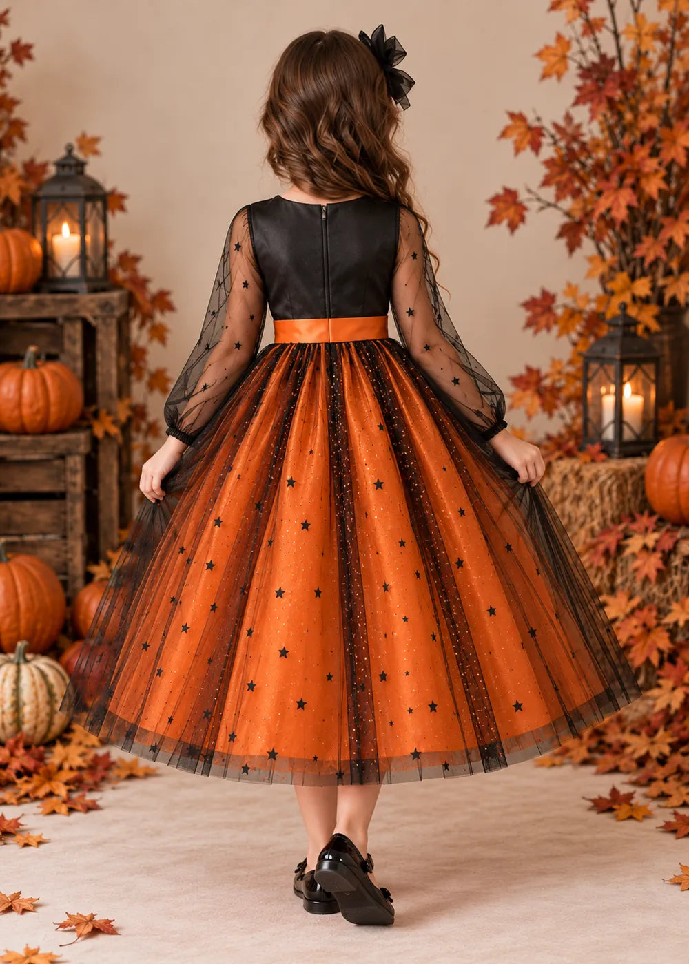 Back view of the orange and black flower girl dress.