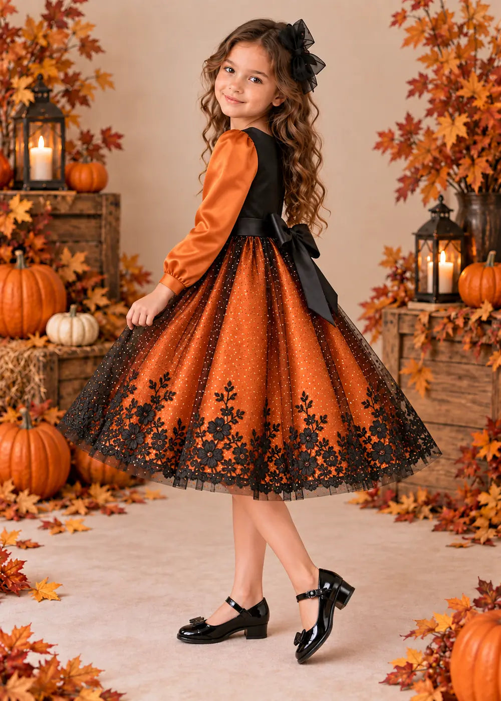 Detail view of the orange and black flower girl dress.