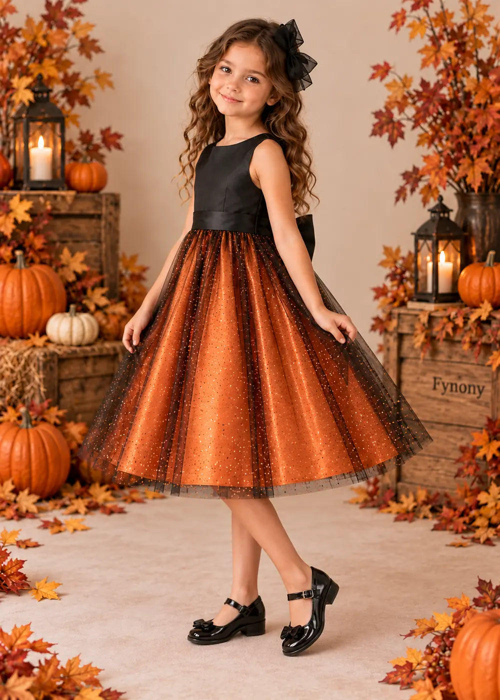 Front three-quarter view of the orange and black dress, showing the rounded neckline and flared below-knee skirt.