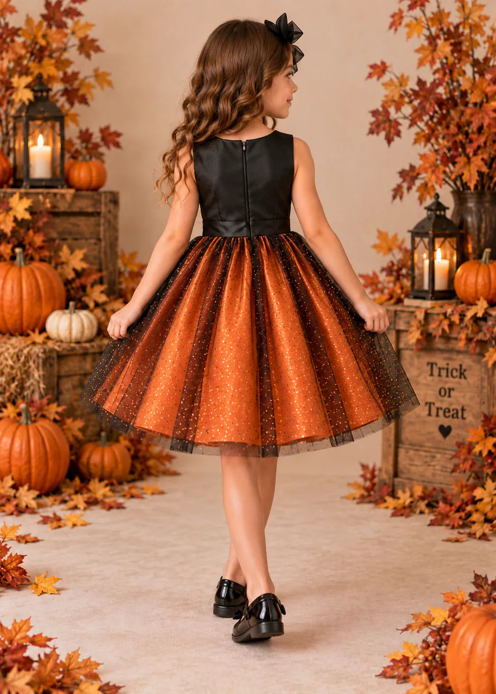 Back view of the orange and black flower girl dress.