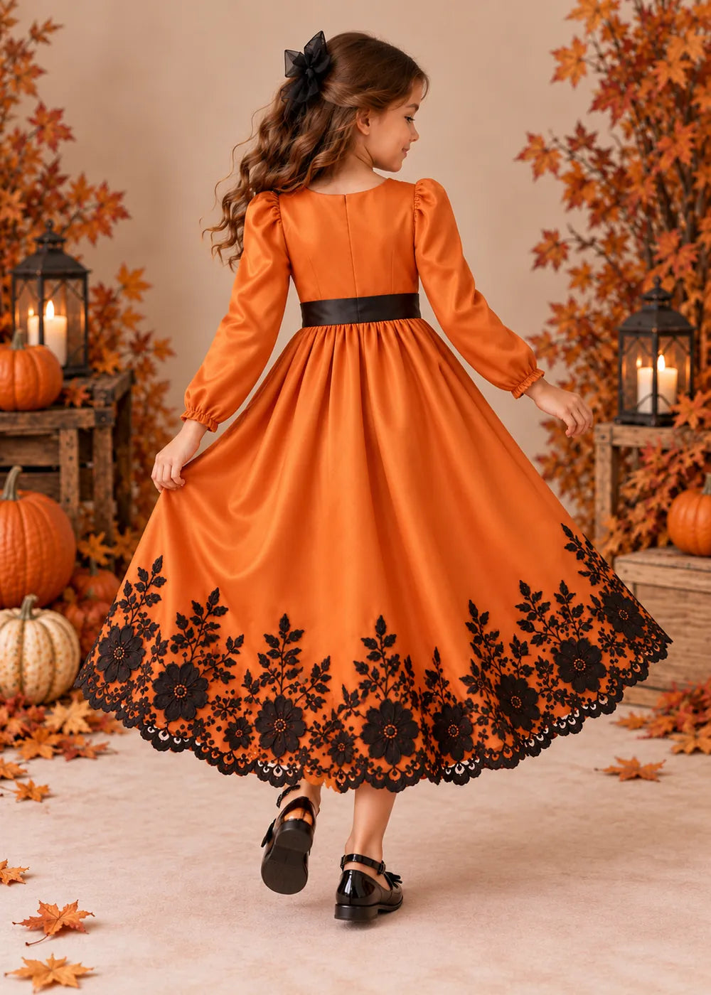 Back view of the orange and black flower girl dress.