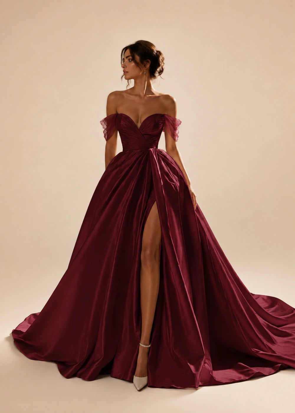 Front view of the burgundy off-the-shoulder A-line gown with a corset bodice, high slit, and train