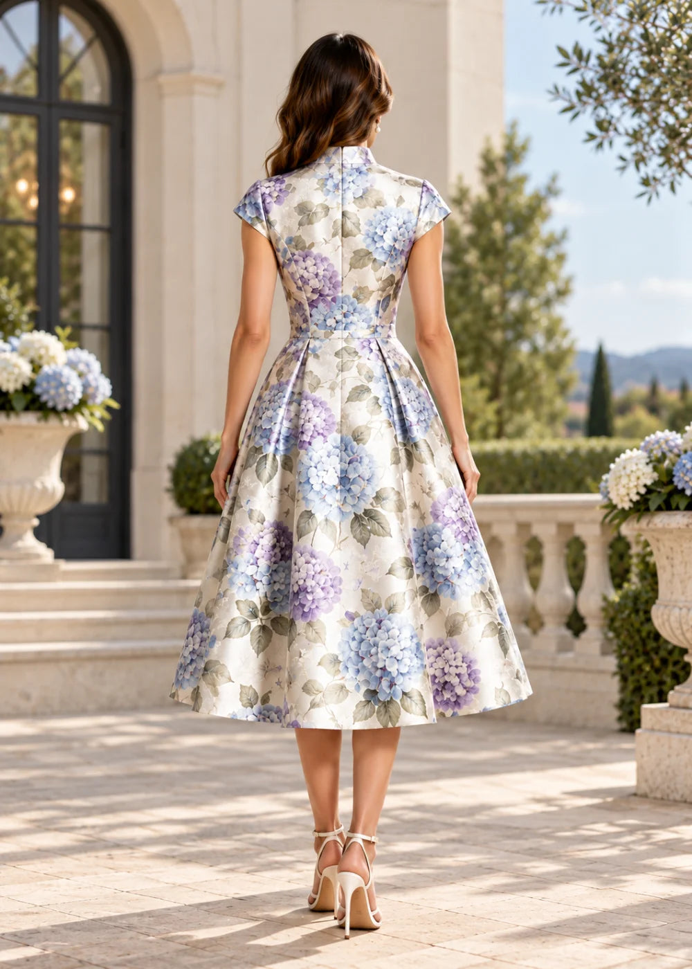 Back view of the ivory high-neck floral A-line midi dress with cap sleeves