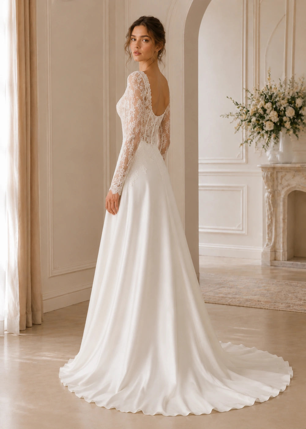 Back view of an ivory corset-style gown showing the low curved backline and train