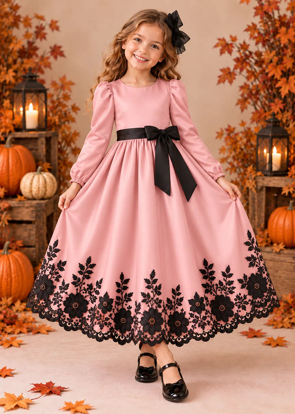 Front view of a blush pink long-Sleeve Flower Girl Dress with Black Floral Hem.
