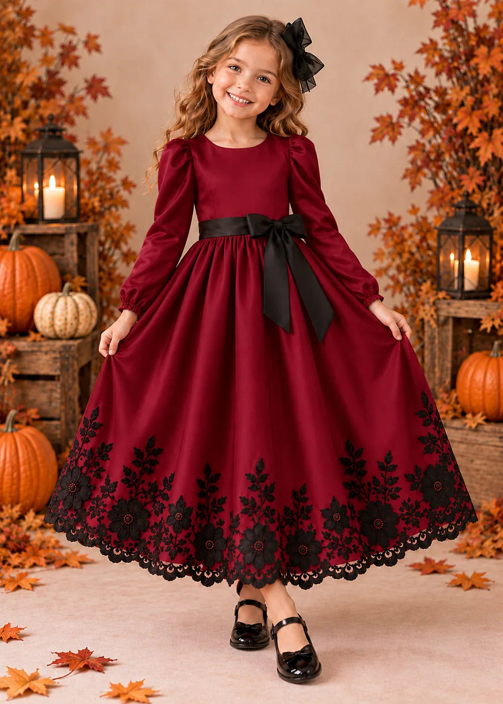 Front view of a burgundy long-Sleeve Flower Girl Dress with Black Floral Hem.