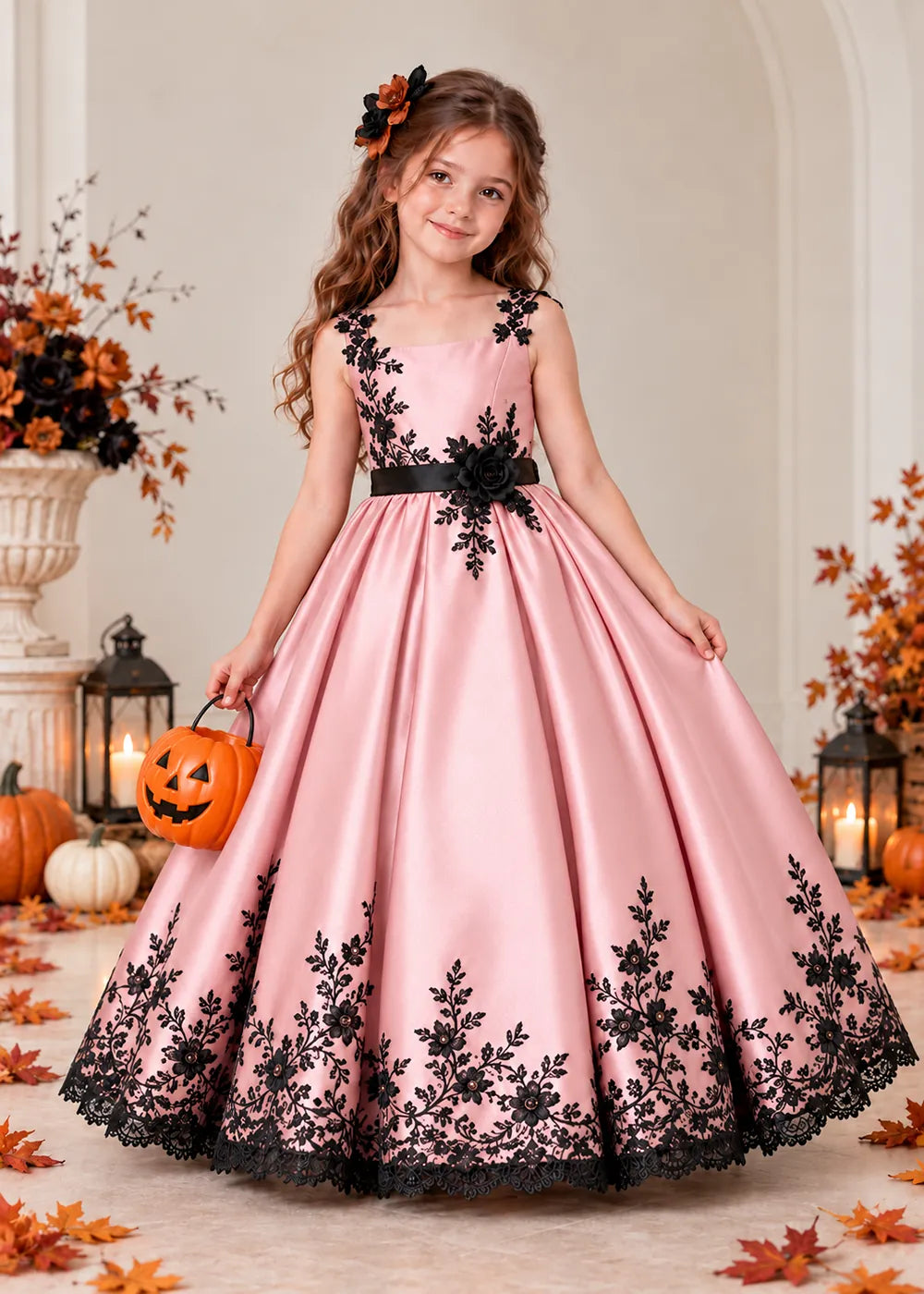Front view of a blush pink flower Girl Dress with Black Floral Straps and Hem.