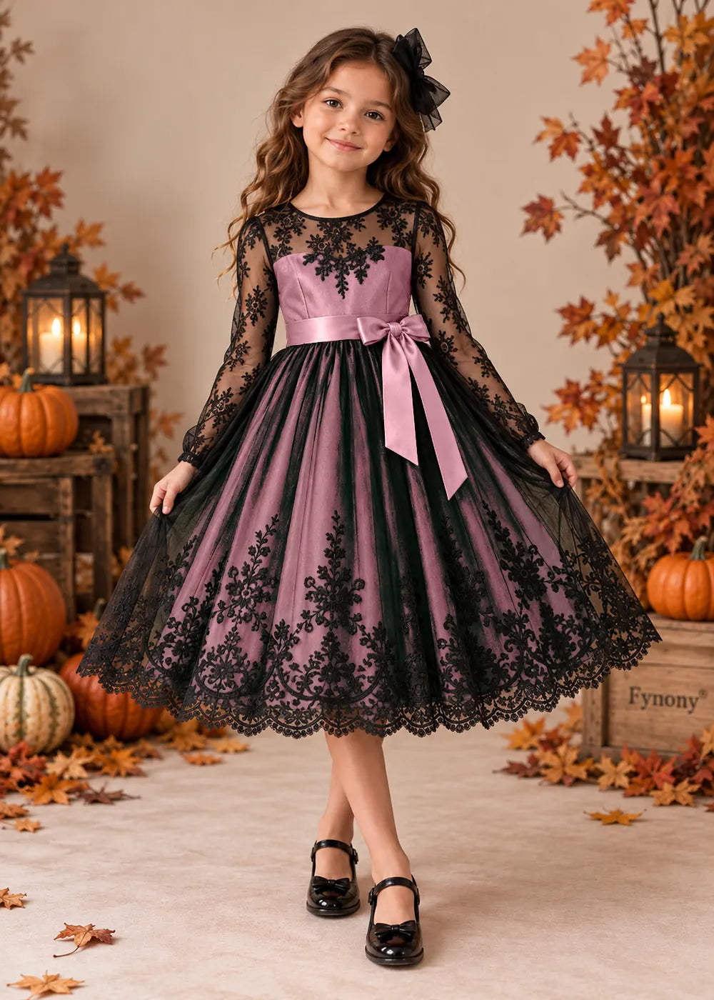 Front view of a blush pink flower Girl Dress with Black Lace and Long Sleeves.