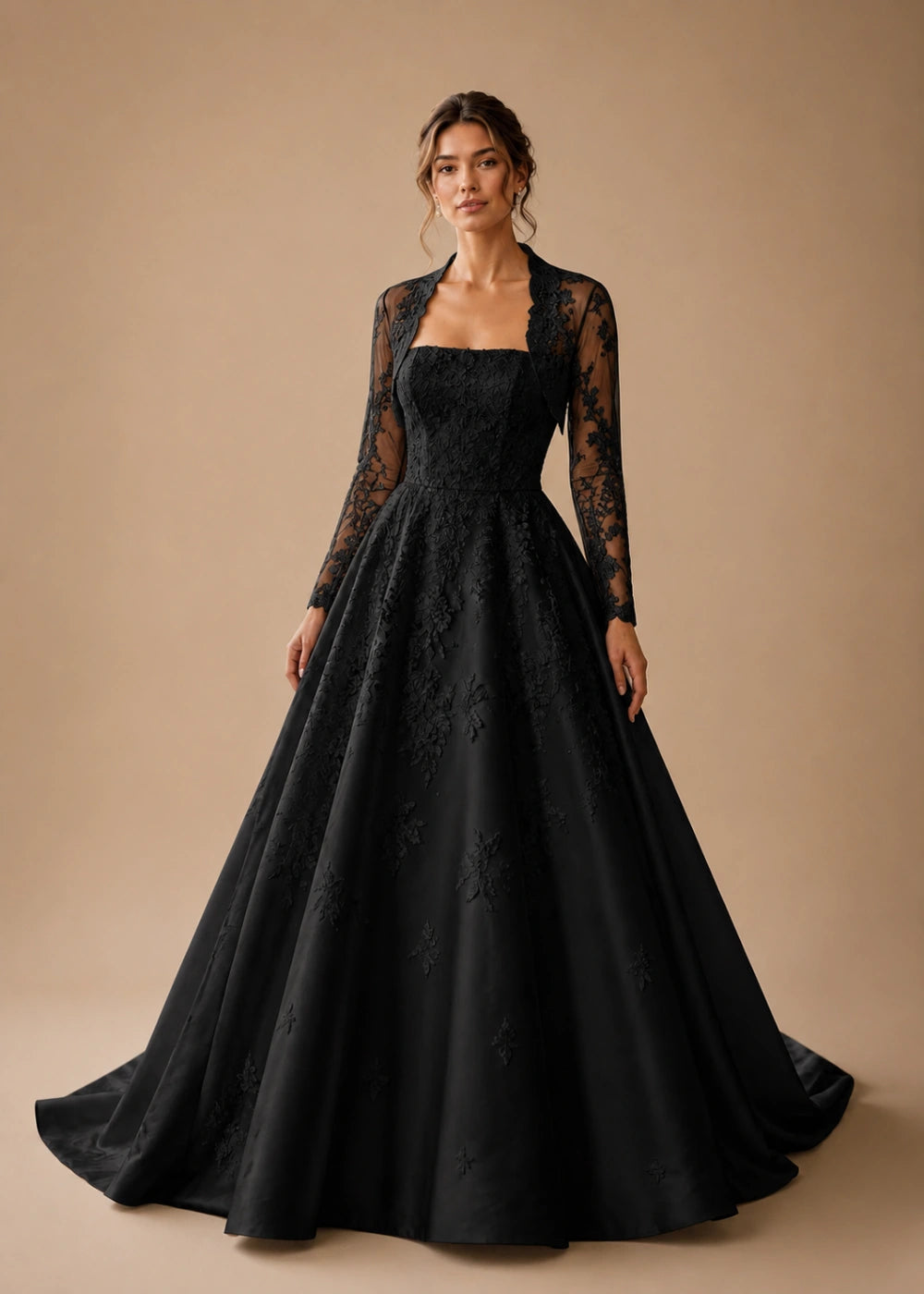 Front view of the black square-neck A-line gown with a long-sleeve lace bolero-style overlay