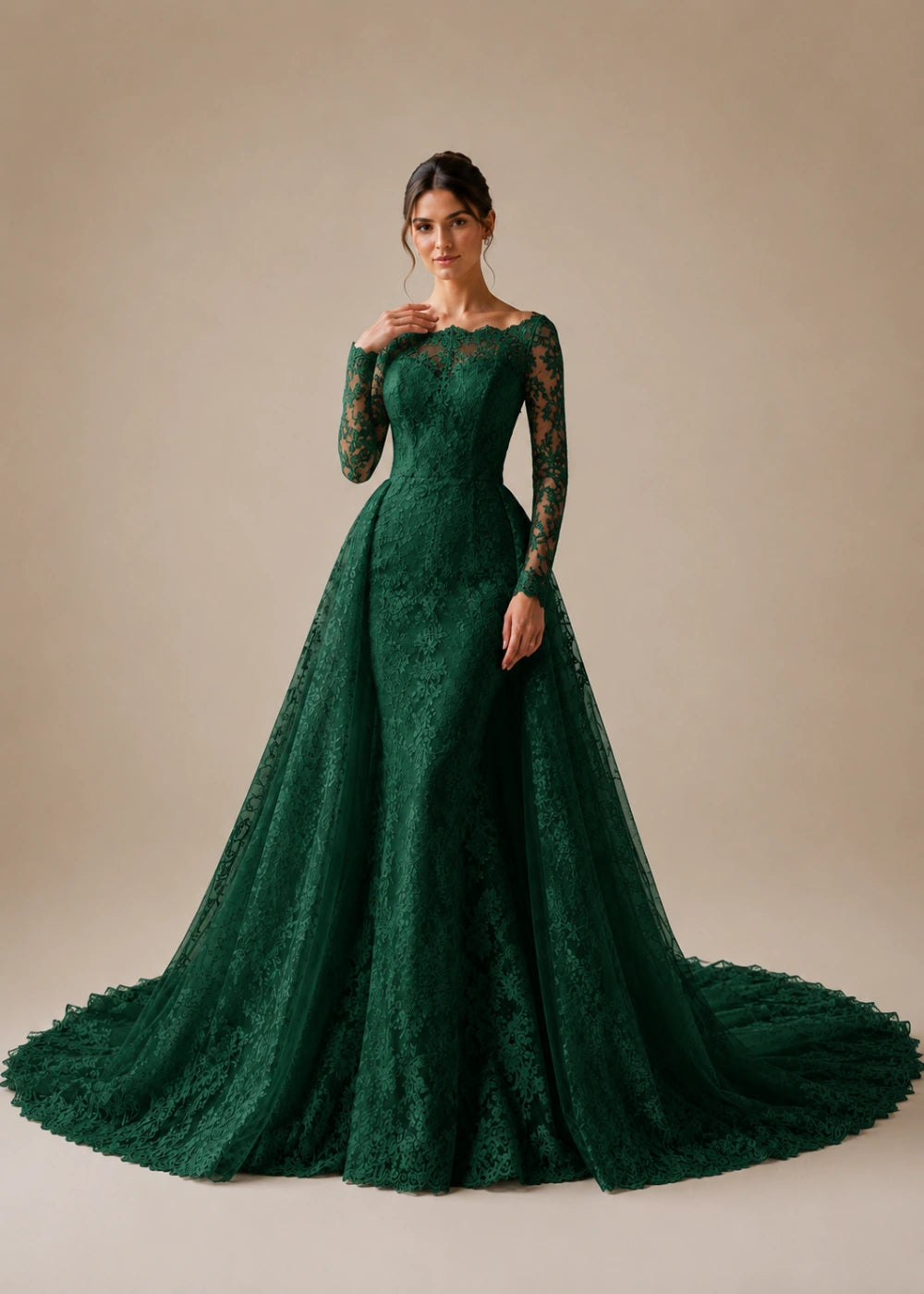 Front view of the emerald green illusion-neck A-line gown with all-over floral lace, long sleeves, and a train