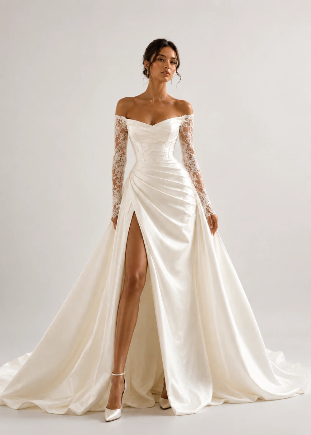 Front view of the ivory off-the-shoulder A-line gown with long lace sleeves and a thigh-high slit