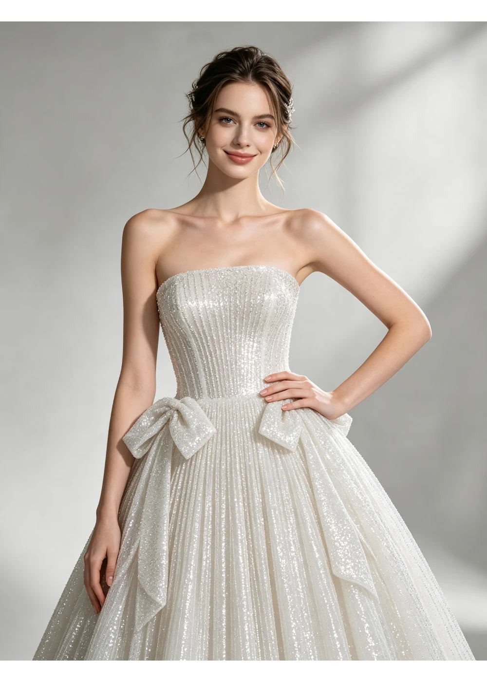 Close view of the straight ivory neckline and paired waist bows
