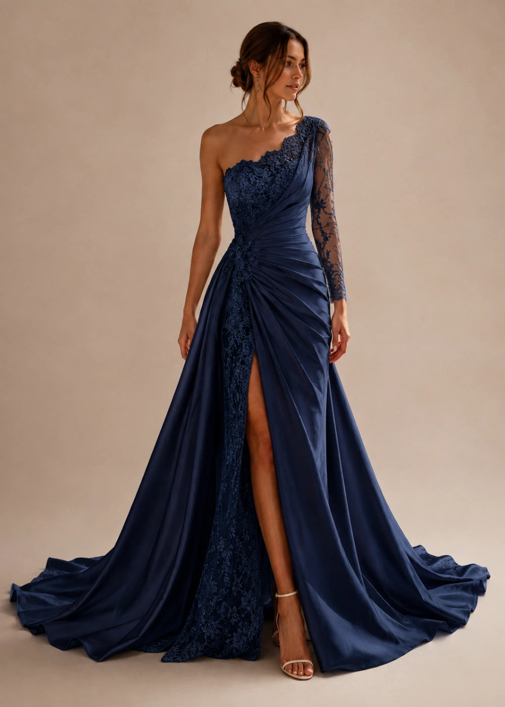 Front view of the navy blue one-shoulder fitted gown with one long lace sleeve, a thigh-high slit, and a train