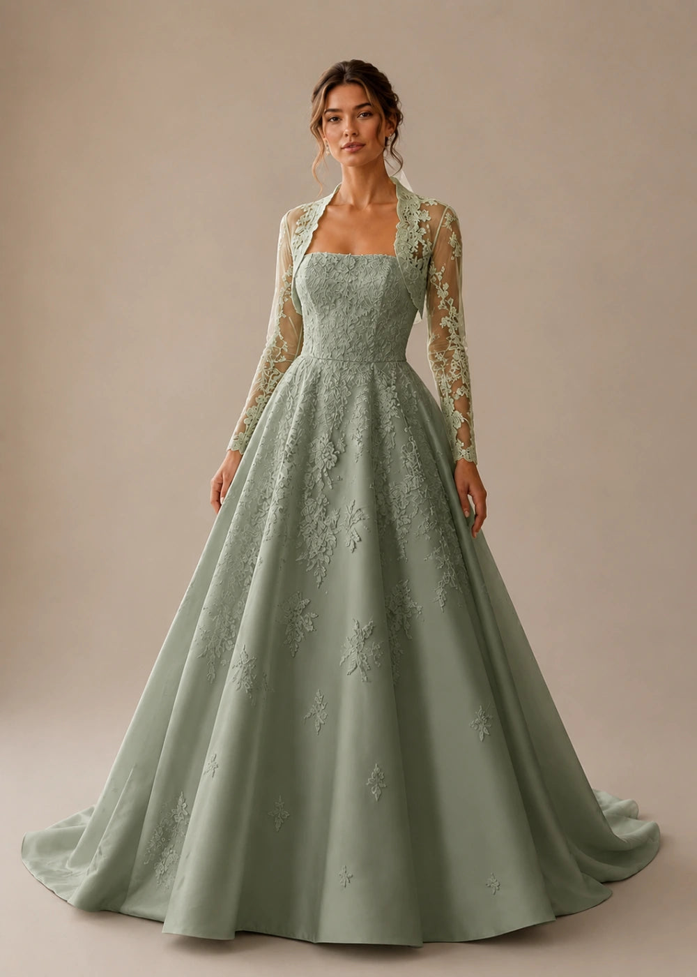 Front view of the sage green square-neck A-line gown with a long-sleeve lace bolero-style overlay